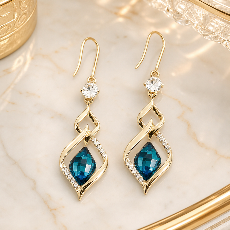Blue glass twist drop earrings on ivory marble