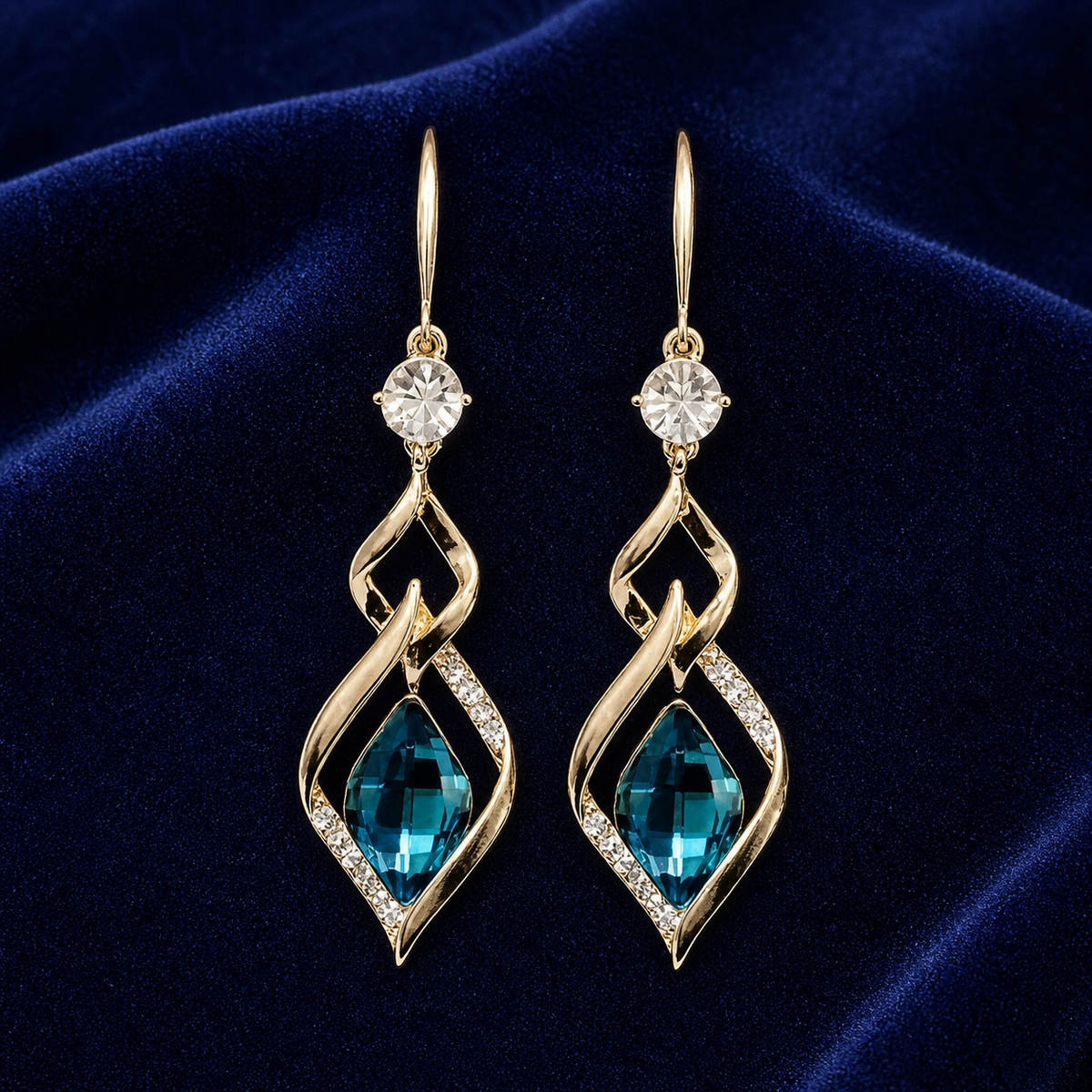 Blue glass twist drop earrings on navy velvet
