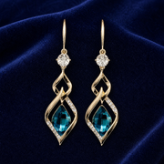 Blue glass twist drop earrings on navy velvet