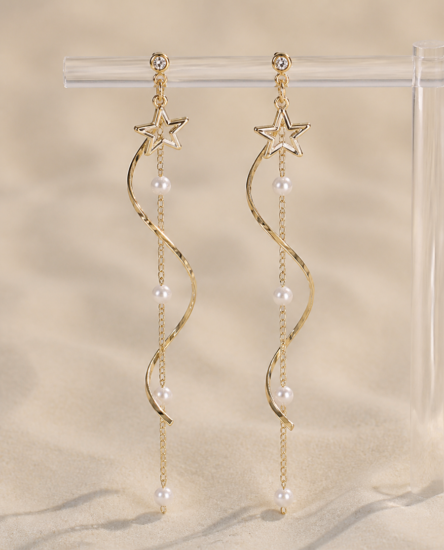 Cascading star and pearl earrings on display