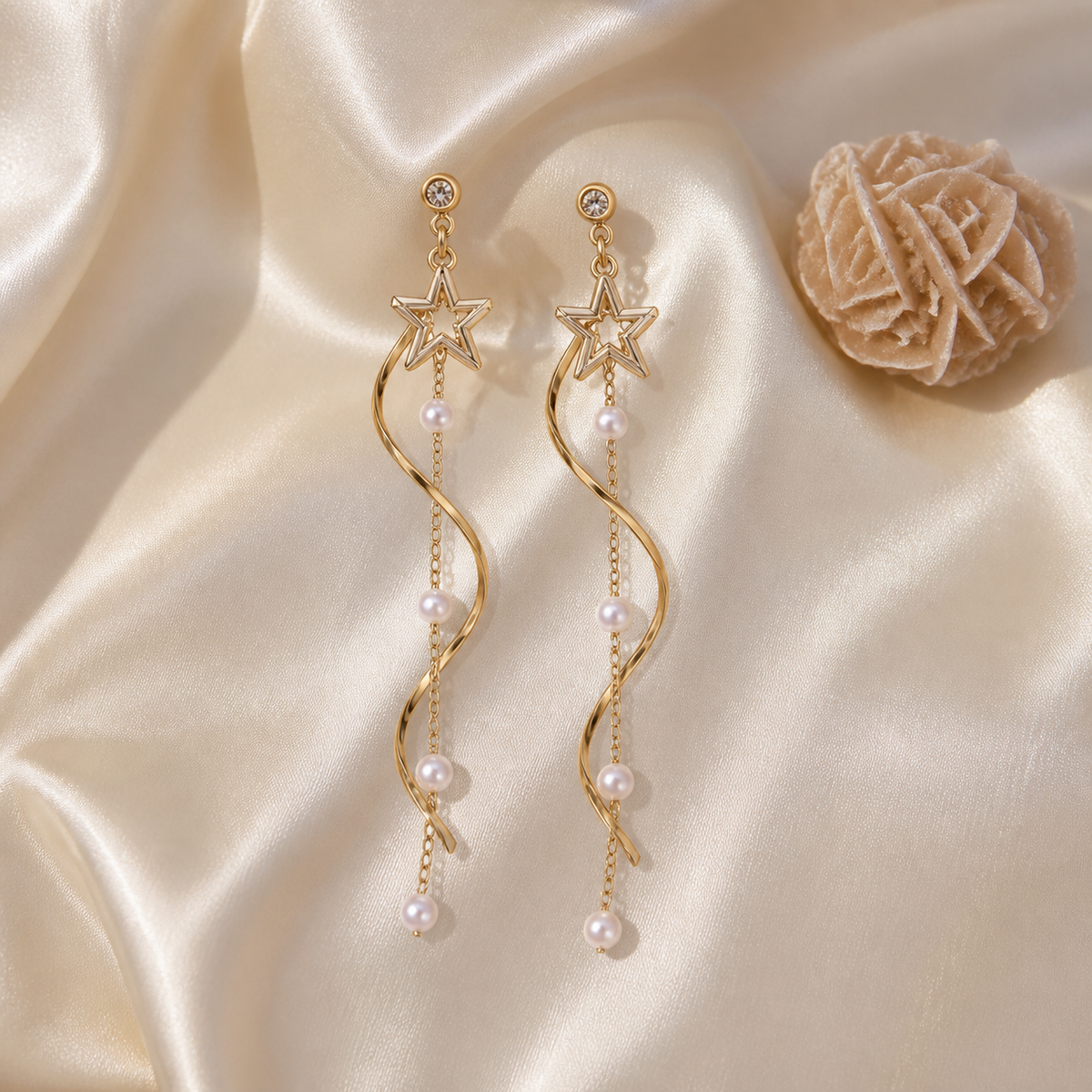 Cascading star and pearl earrings on ivory silk