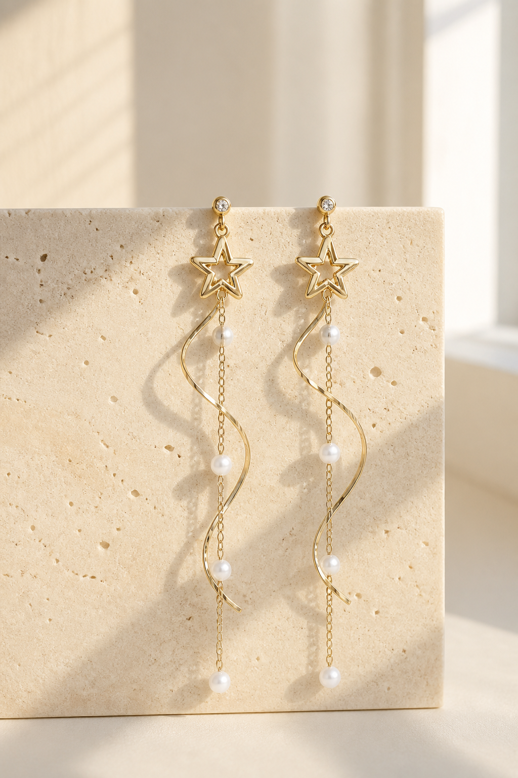 Gold-tone cascading star and pearl earrings