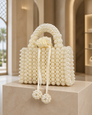 Pearl-beaded rose-handle evening clutch in white, three-quarter view